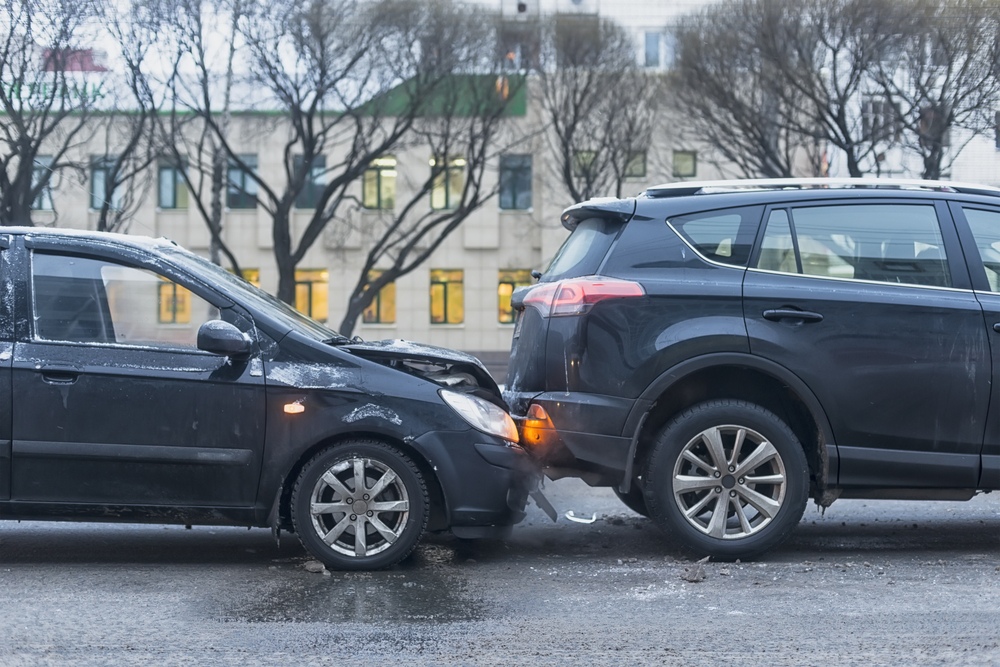 Cars crash into one another on a wet road